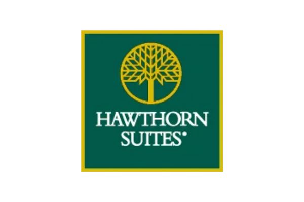 'Green and yellow Hawthorn Suites logo with tree design.'